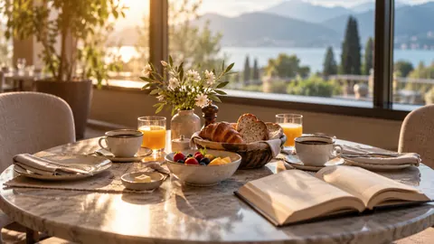 Illustration of a hotel breakfast table for two with an open book beside one place.