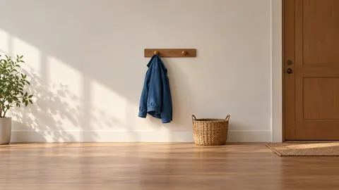 Illustration of a blue jacket on a coat hook beside an empty hook and a woven basket.